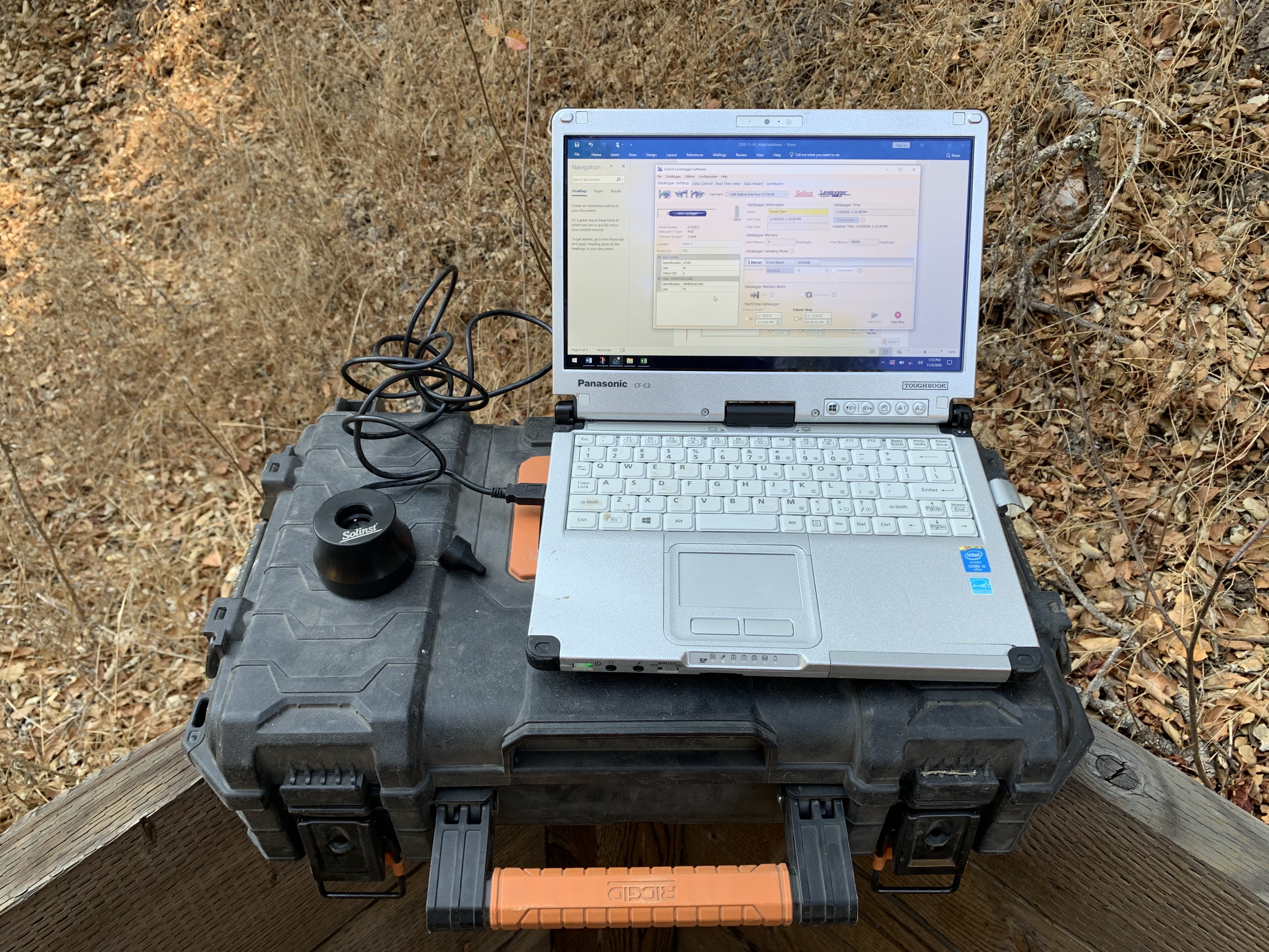 Computer recording data on the ground.